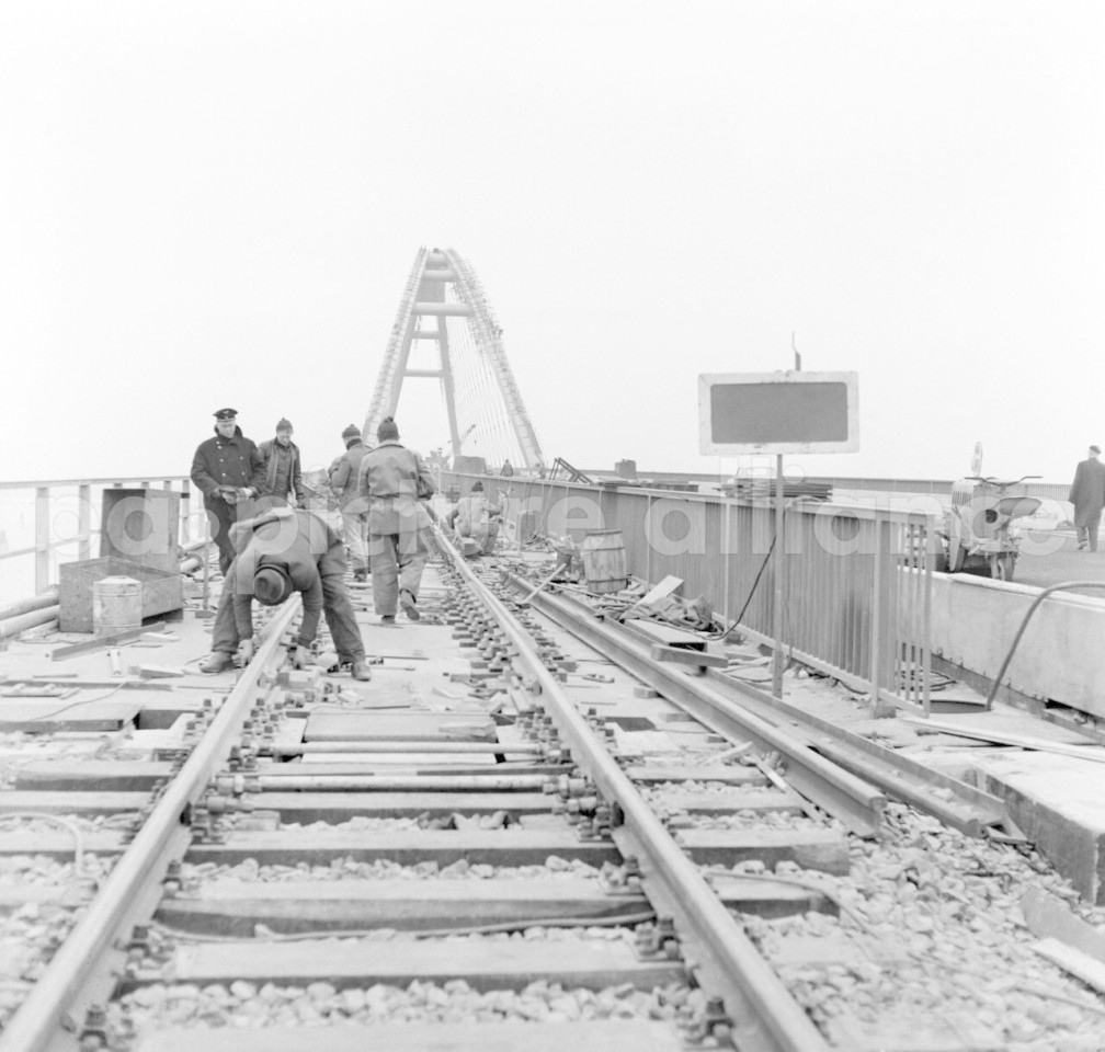 Fehmarn 1963: Schienenmontage der Bundesbahn neben der Fahrbahn für den Autoverkehr.