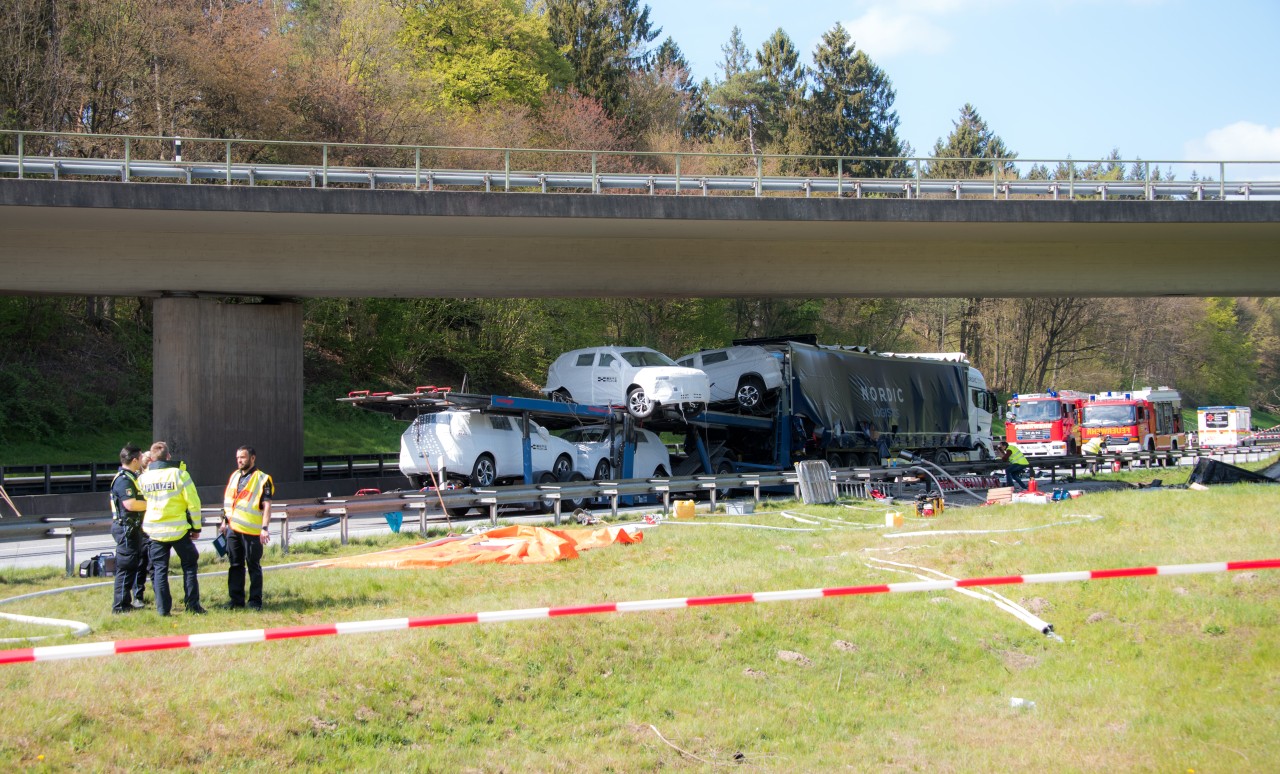 Einsatzkräfte stehen auf der Autobahn A261 im Stadtteil Marmstorf in Hamburg an einer Unfallstelle. Ein Autotransporter ist auf einen Sattelzug aufgefahren, der Fahrer kam dabei ums Leben.